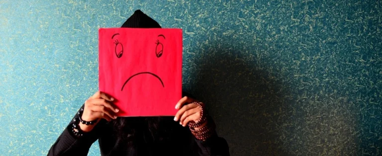 Anxiety symptoms observed in a child afraid of being seen by others and hiding behind paper cover, anxiety vs stress