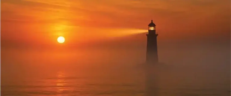 consistency compels attention - Lighthouse beam at sunrise over calm sea symbolizing steady consistency that attracts attention and guide's traffic